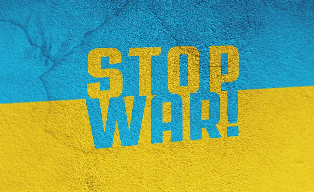 a blue and yellow wall with the words stop war painted on it